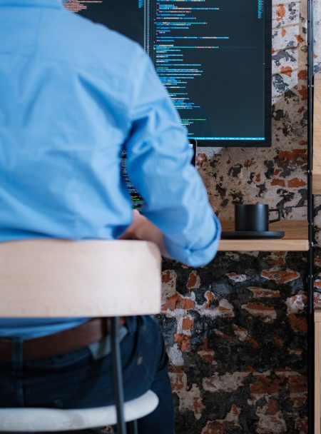 Coder coding in a wallmounted desk